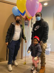 Family holding balloons