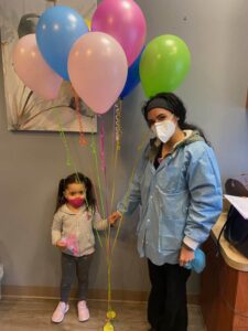 Girl holding balloons