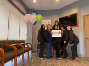 Peach Smiles team with balloons