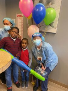 Kids holding giant toothbrush