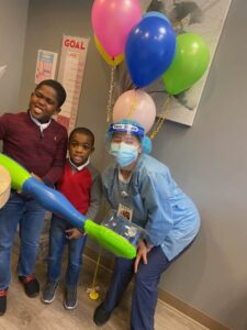 Kids holding giant toothbrush